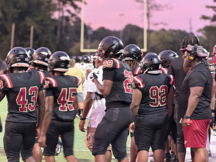 football players walk out onto the field