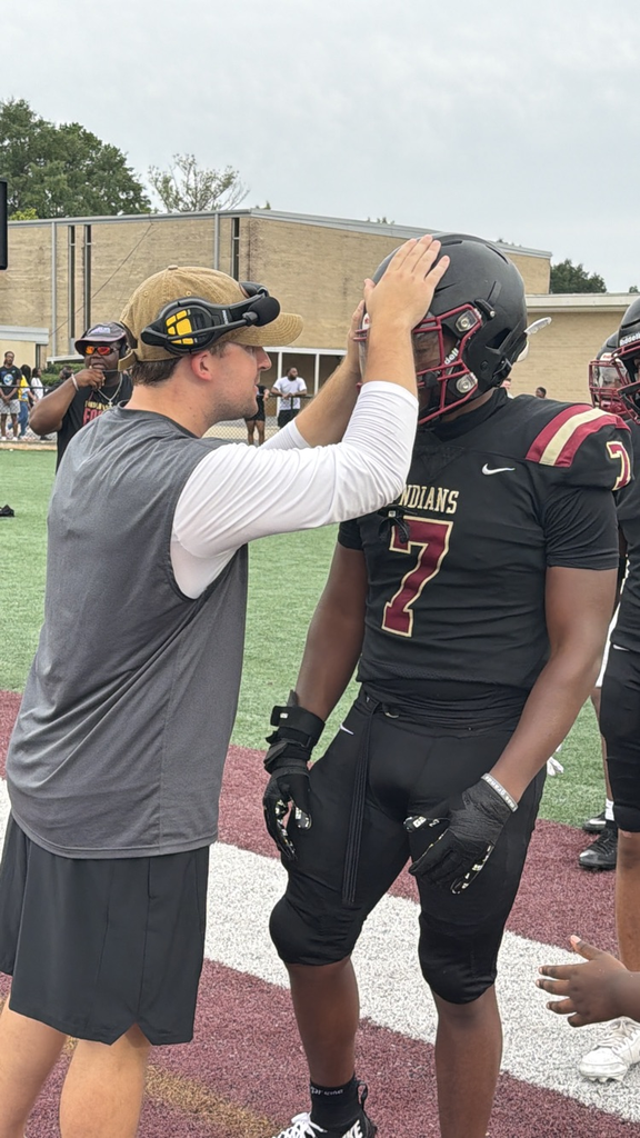 a coach encourages a football player