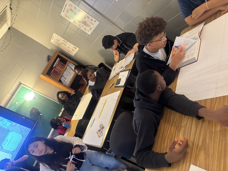 students work in groups to create posters 