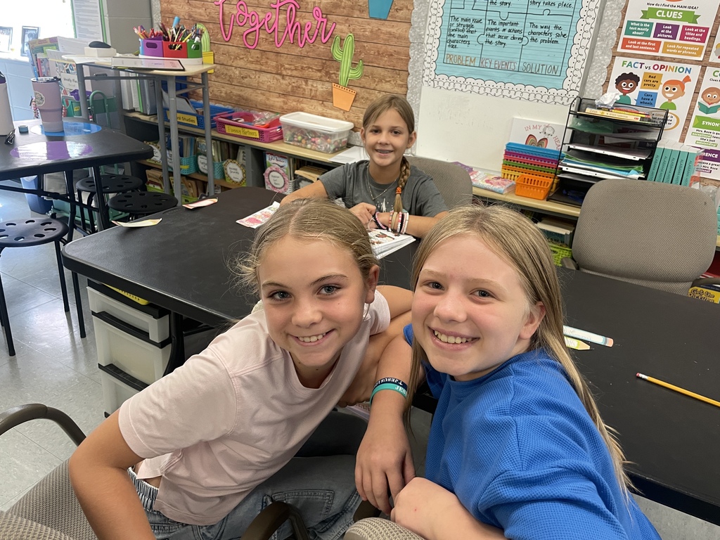 two students siting in a 5th grade classroom