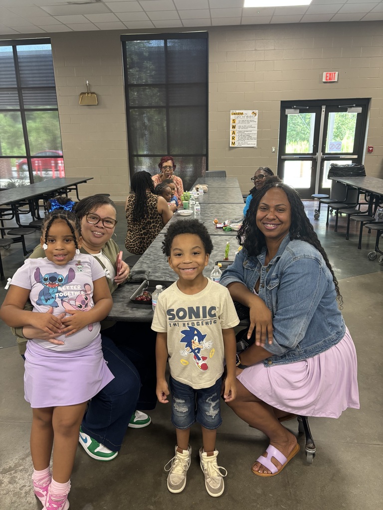 Grandparents and students smiling together during the school’s Grandparents Day Brunch. Families are gathered around tables enjoying breakfast, visiting, and celebrating time together on campus.