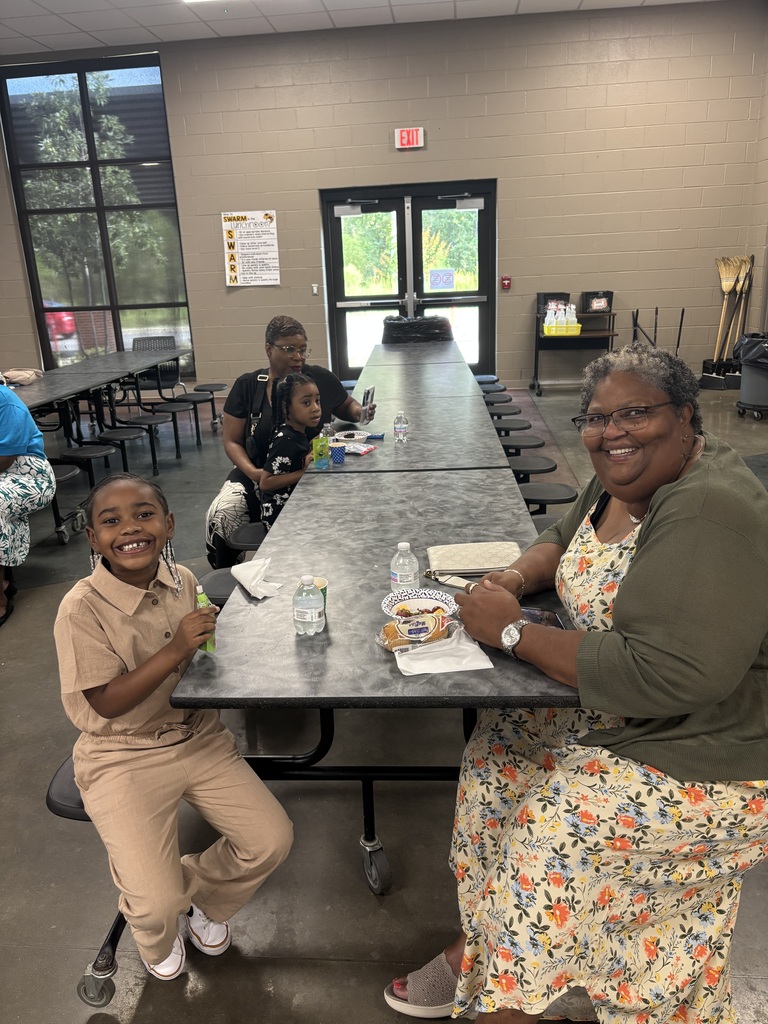 Grandparents and students smiling together during the school’s Grandparents Day Brunch. Families are gathered around tables enjoying breakfast, visiting, and celebrating time together on campus.