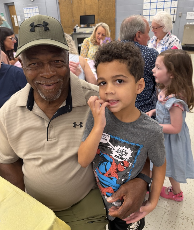 a grandad and kindergarten student smiling