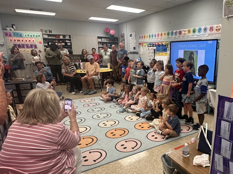 Grandparents watching grandkids in classroom