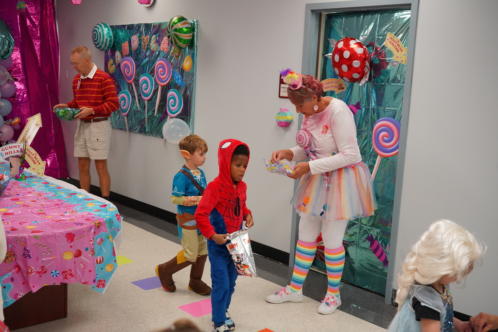 Students dressed up for Halloween and getting candy.