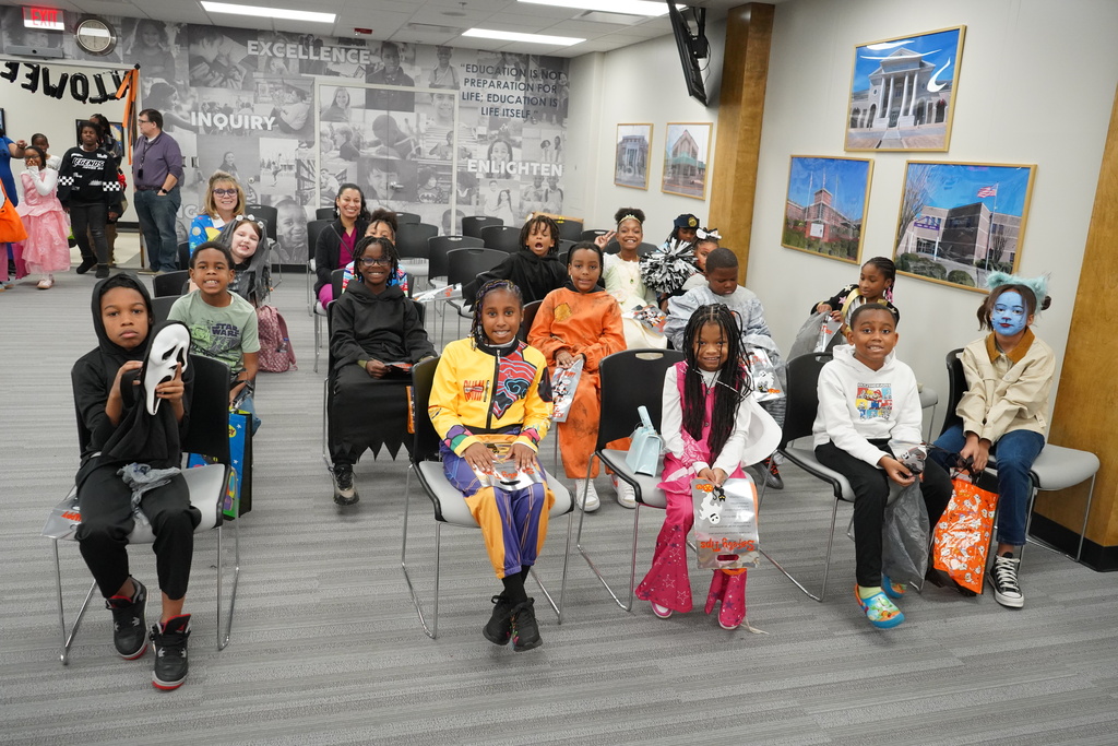 Students dressed up for Halloween and getting candy.
