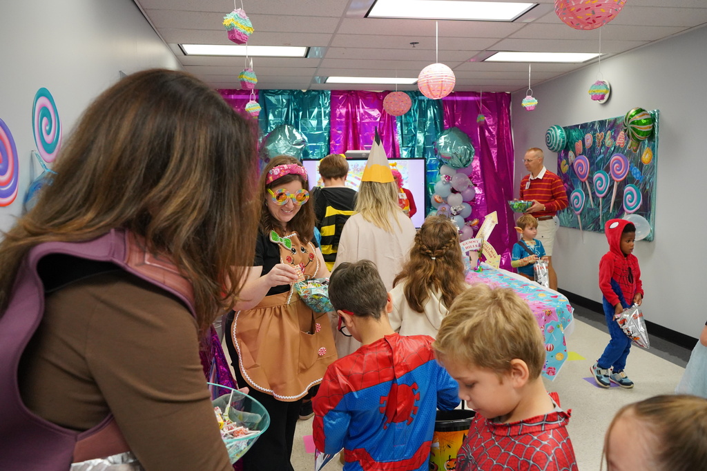Students dressed up for Halloween and getting candy.