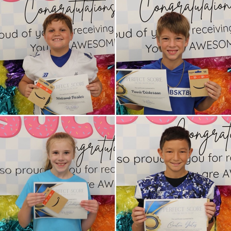 four children holding certificates and gift cards smiling