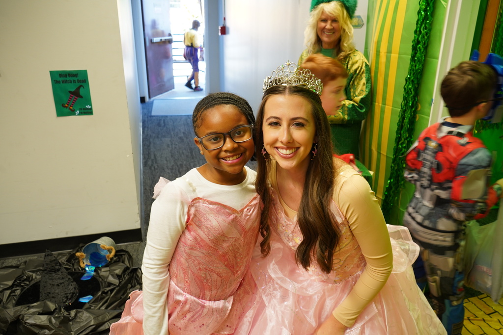 Student and adult both dressed as Glenda from Wizard of Oz. 