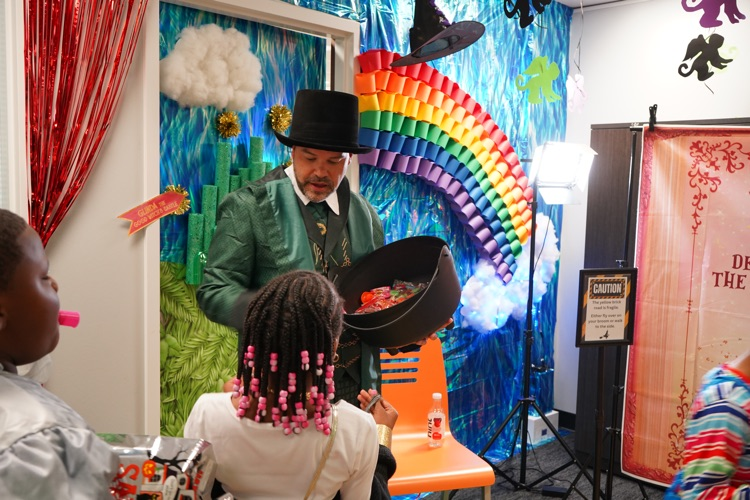 man dressed as leprechaun passing out candy