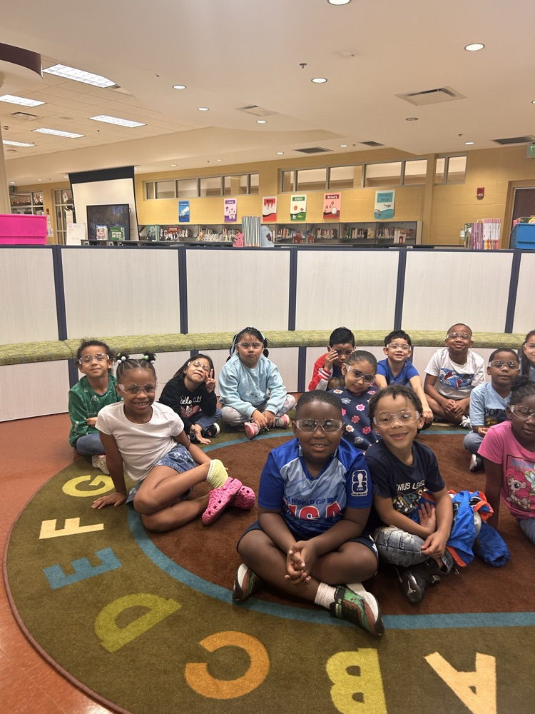 students sitting on a rug wearing goggles