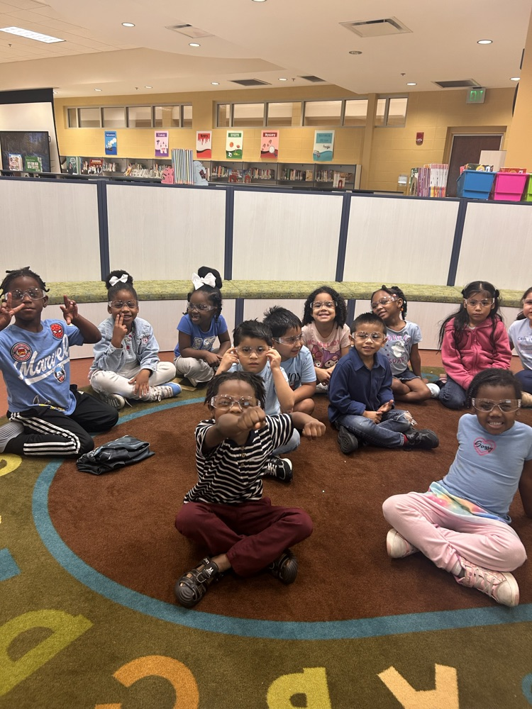 students sitting on a rug wearing goggles