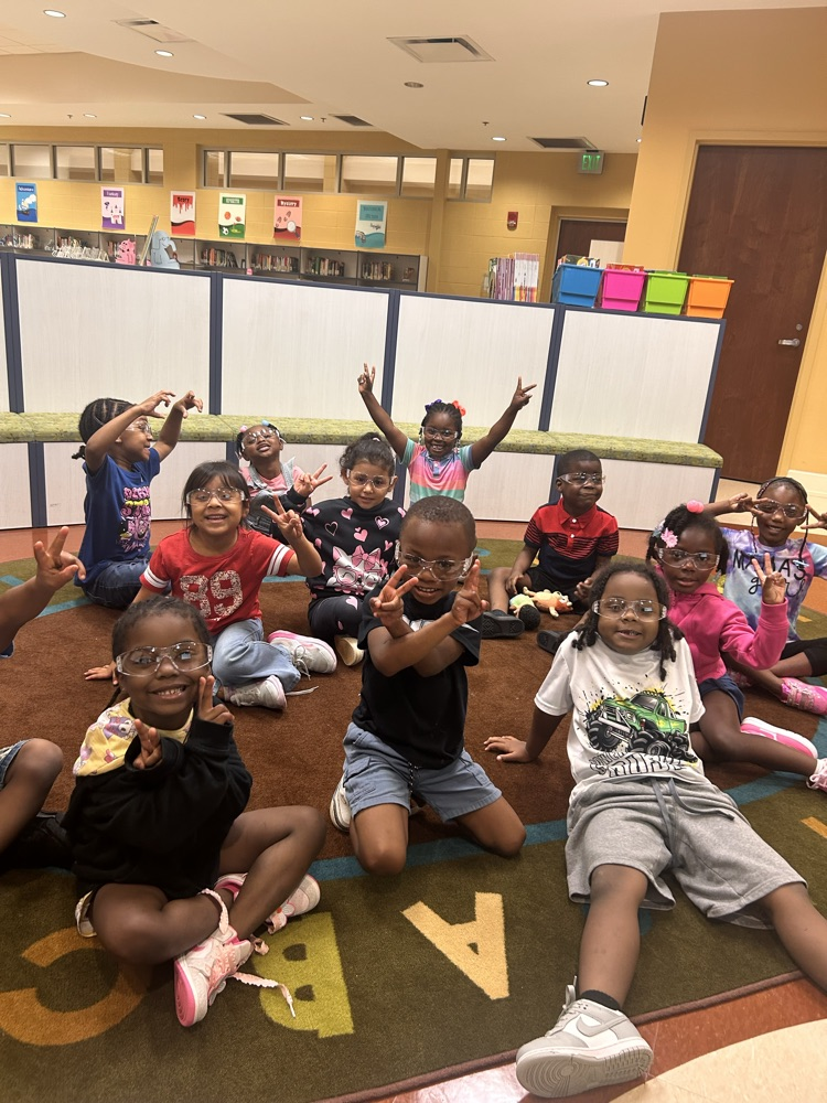 students sitting on a rug wearing goggles