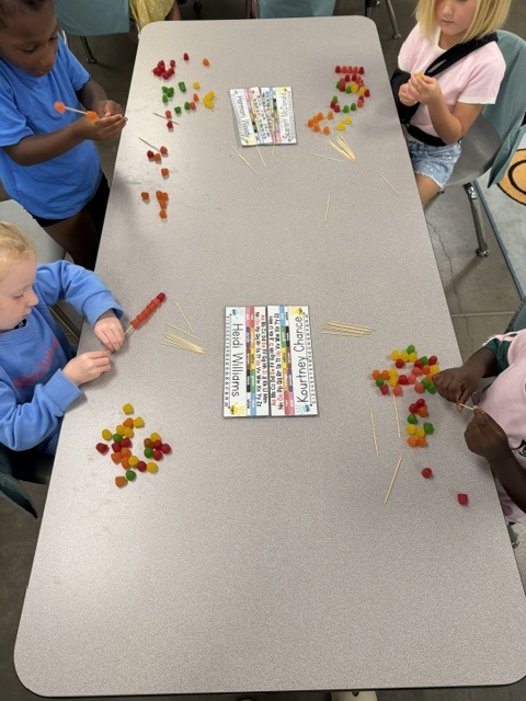 students at table making shapes with dot candy and tooth picks