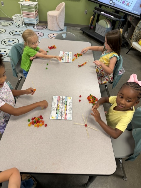 students at table making shapes with dot candy and tooth picks