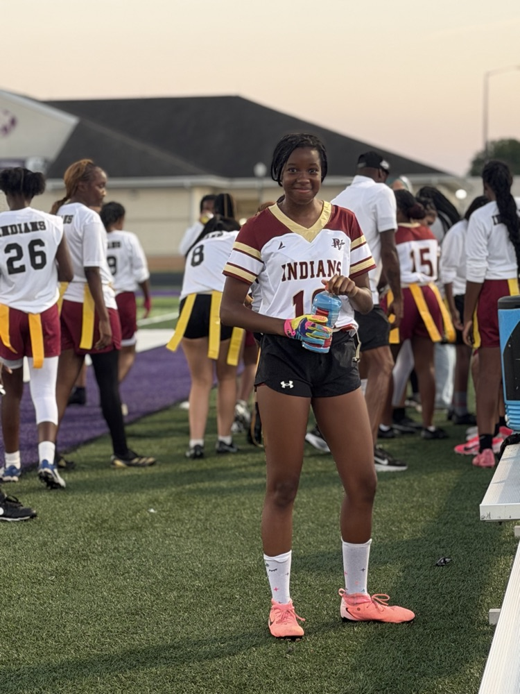 a flag football player poses for a photo on the field 