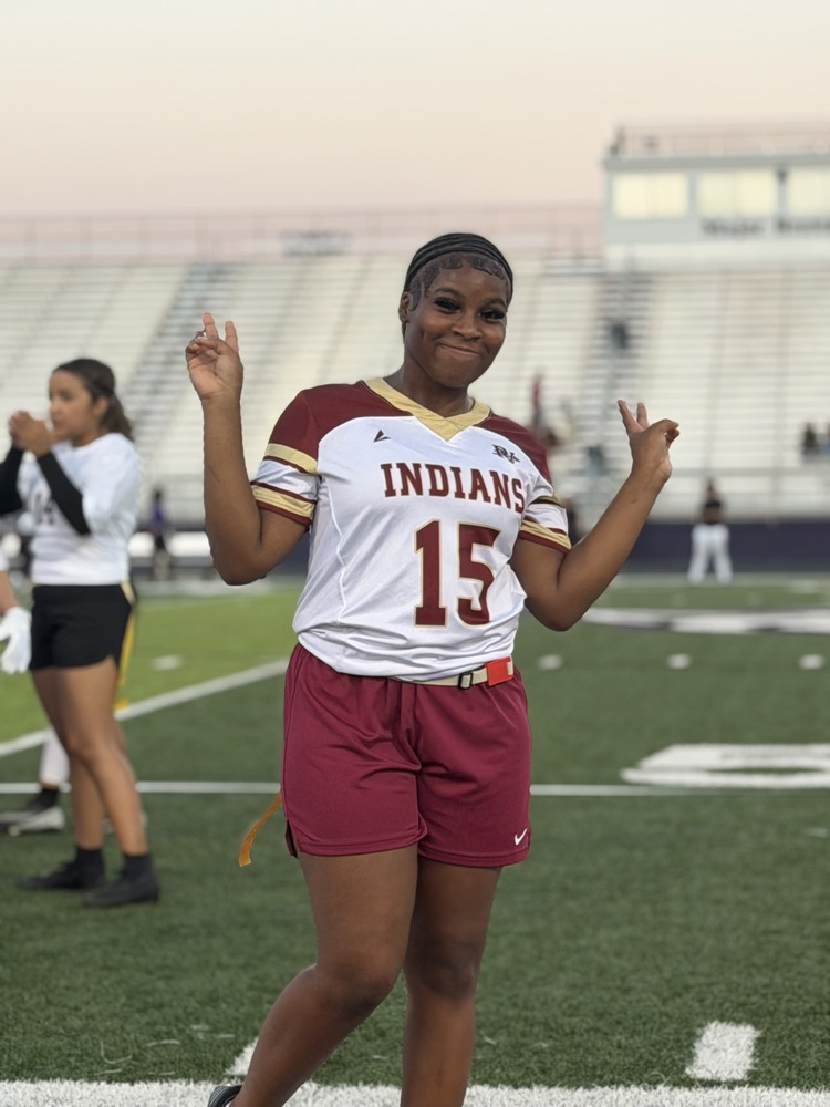 a flag football player poses for a photo on the field 