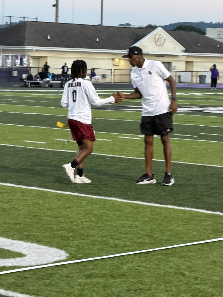 a play shakes hands with a coach