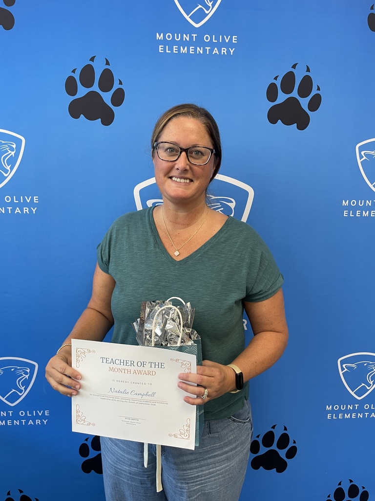 Teacher holding certificate and gift