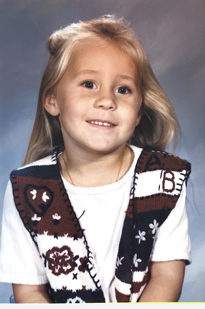 A childhood school portrait of a McCalla Elementary teacher or staff member, shared as part of a fun Picture Day guessing game for families.