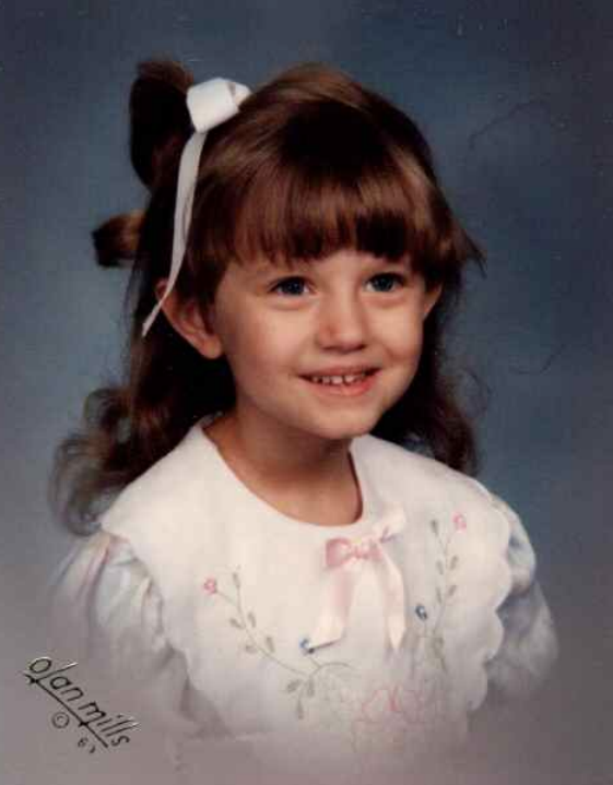 A childhood school portrait of a McCalla Elementary teacher or staff member, shared as part of a fun Picture Day guessing game for families.