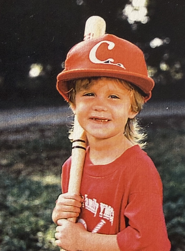 A childhood school portrait of a McCalla Elementary teacher or staff member, shared as part of a fun Picture Day guessing game for families.