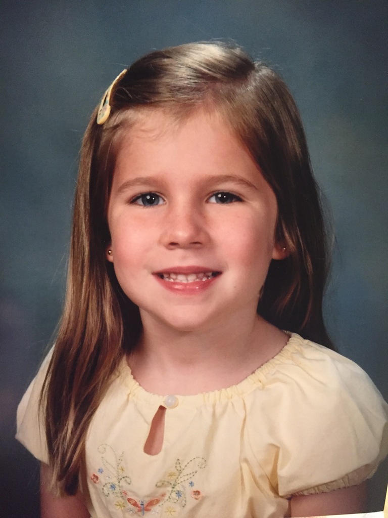 A childhood school portrait of a McCalla Elementary teacher or staff member, shared as part of a fun Picture Day guessing game for families.