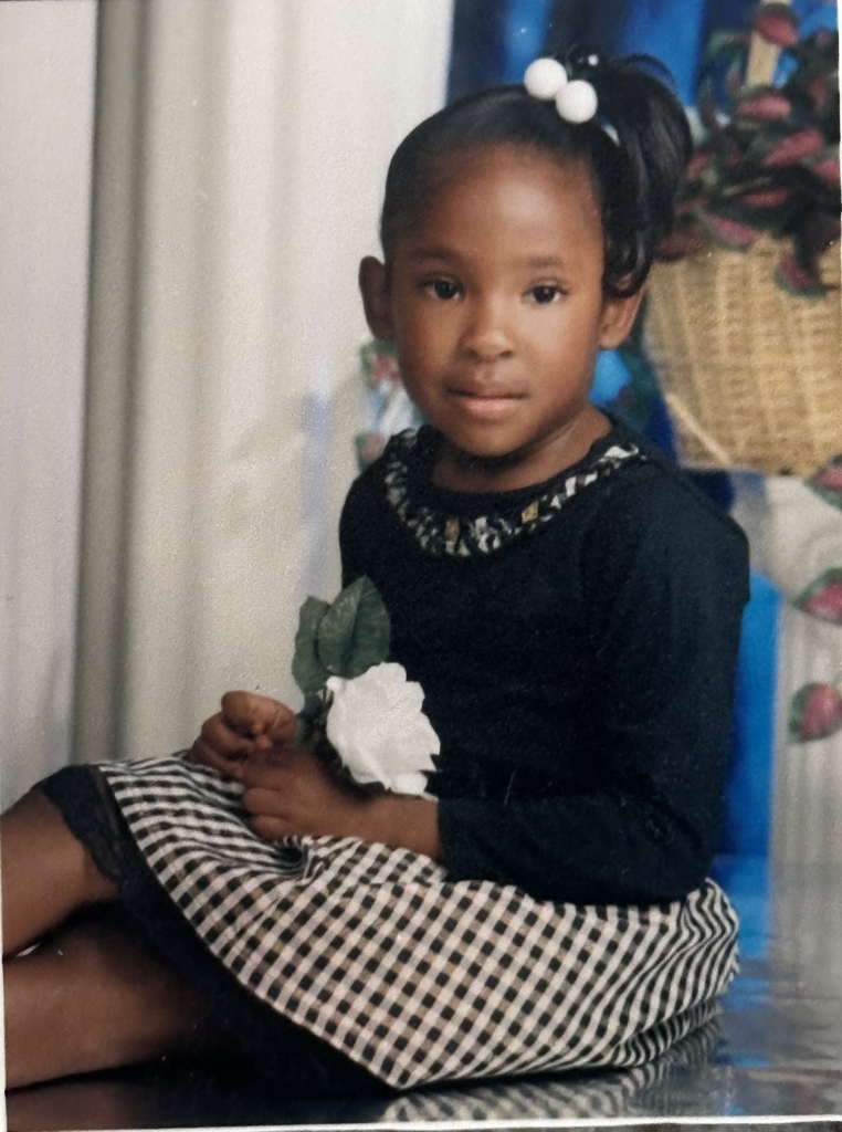 A childhood school portrait of a McCalla Elementary teacher or staff member, shared as part of a fun Picture Day guessing game for families.