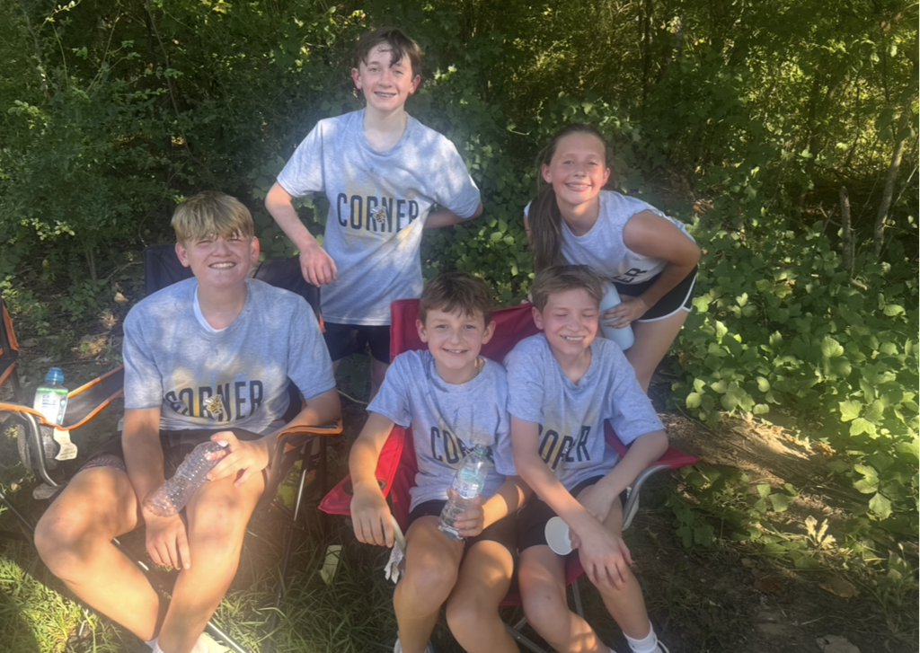 four male and one female cross country runner after a race