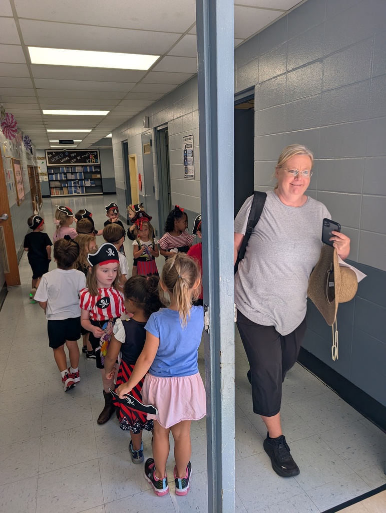 Students dressed up like pirates walking to class with teacher