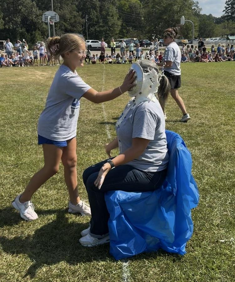 a child giving Dr. Wilson a pie in the face!