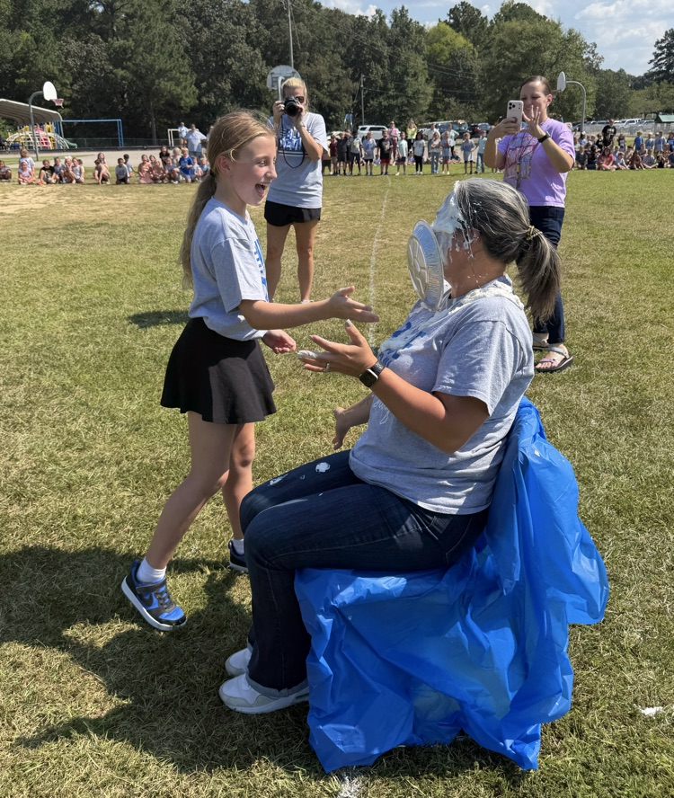 a child giving Dr. Wilson a pie in the face