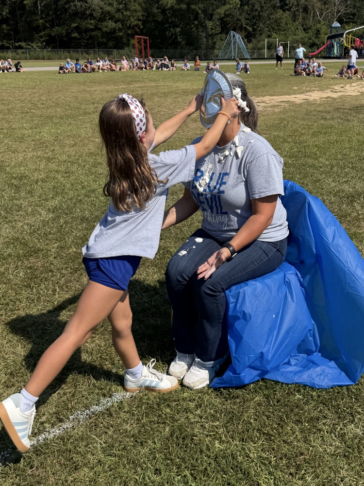 a child giving Dr. Wilson a pie in the face
