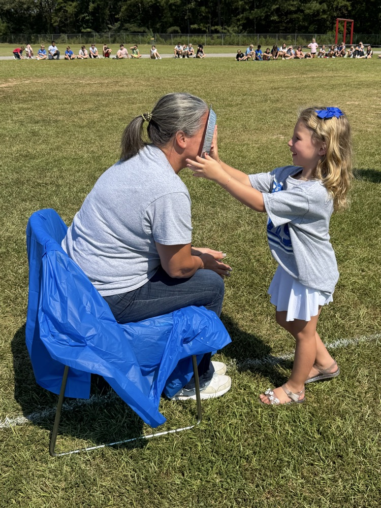a child giving Dr. Wilson a pie in the face