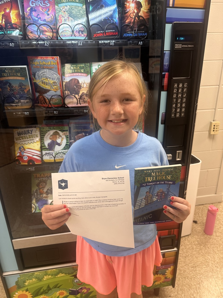 5th grade girl smiling with book and letter