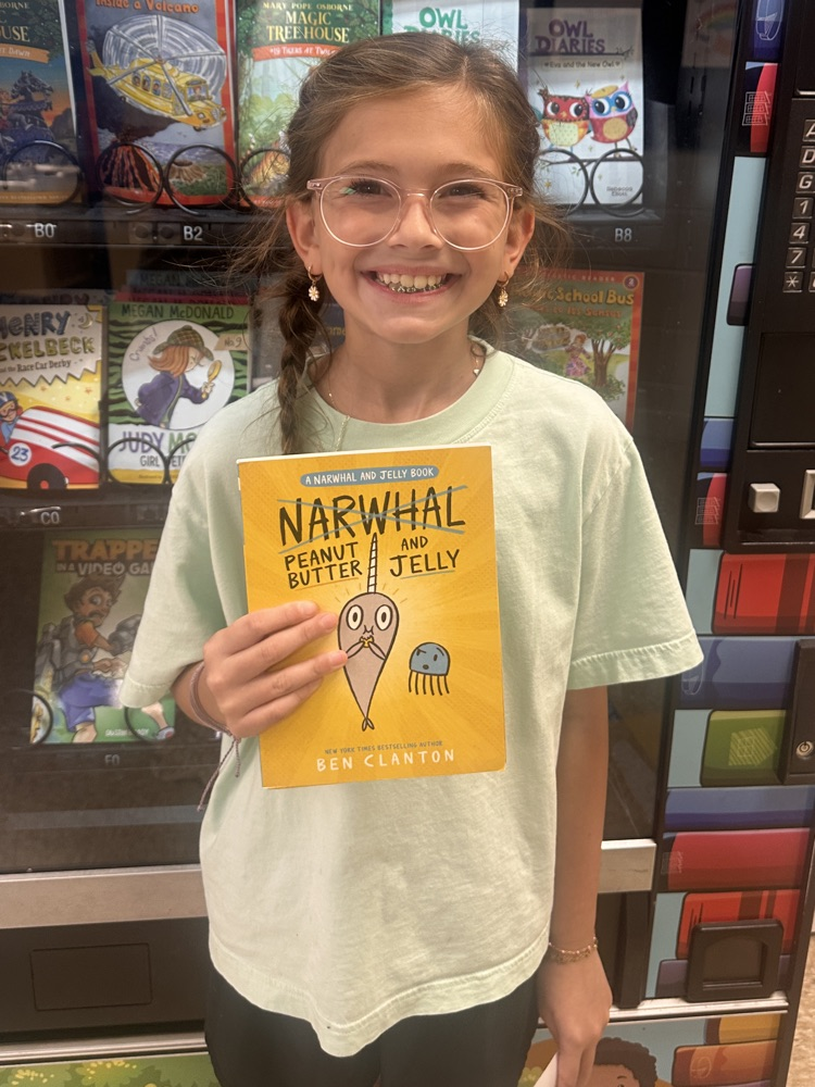 5th grade girl smiling with book
