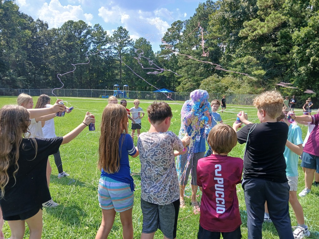 Students spraying the teacher with silly string because they received a 4 on their ACAP