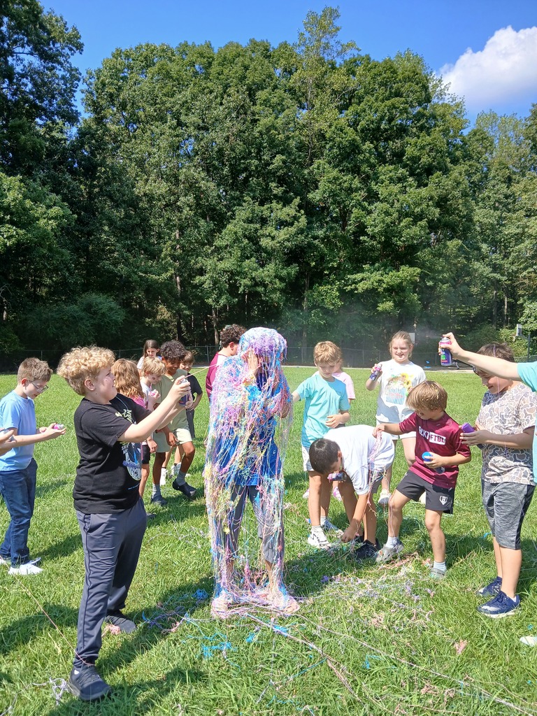 Teacher being sprayed with Silly String for scoring a 4 on ACAP