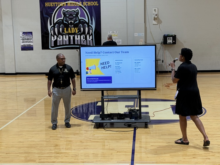 HMS staff share information with families during the Open House presentation.