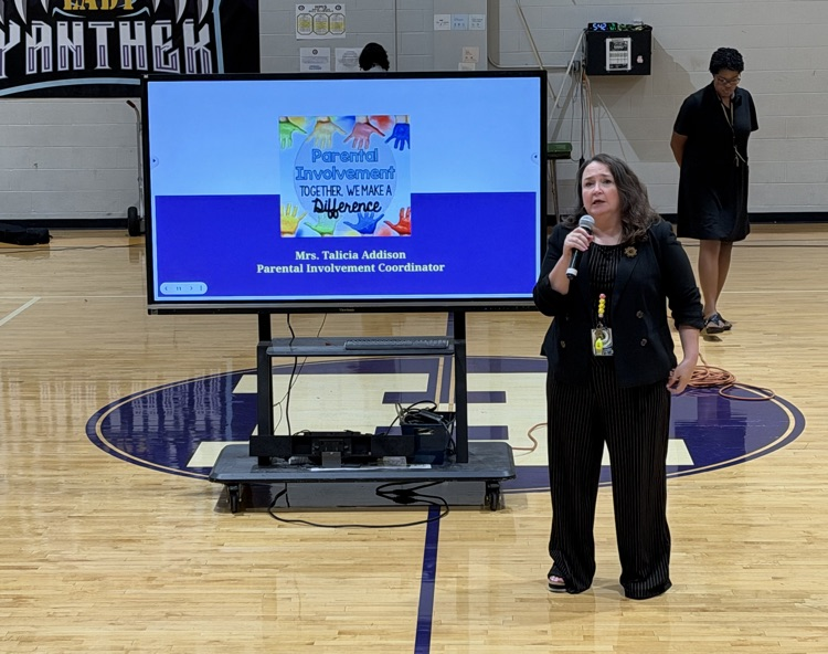 HMS staff share information with families during the Open House presentation.