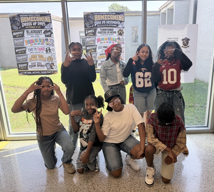 HMS students pose together in front of the Homecoming Week displays for Decades Day.