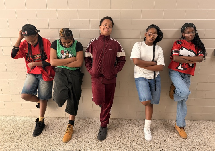Five HMS students pose in throwback-inspired outfits for Homecoming Decades Day.