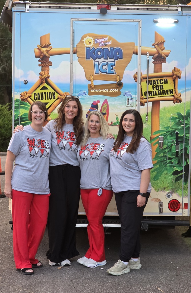 4 teachers standing in front of the Kona Ice truck.
