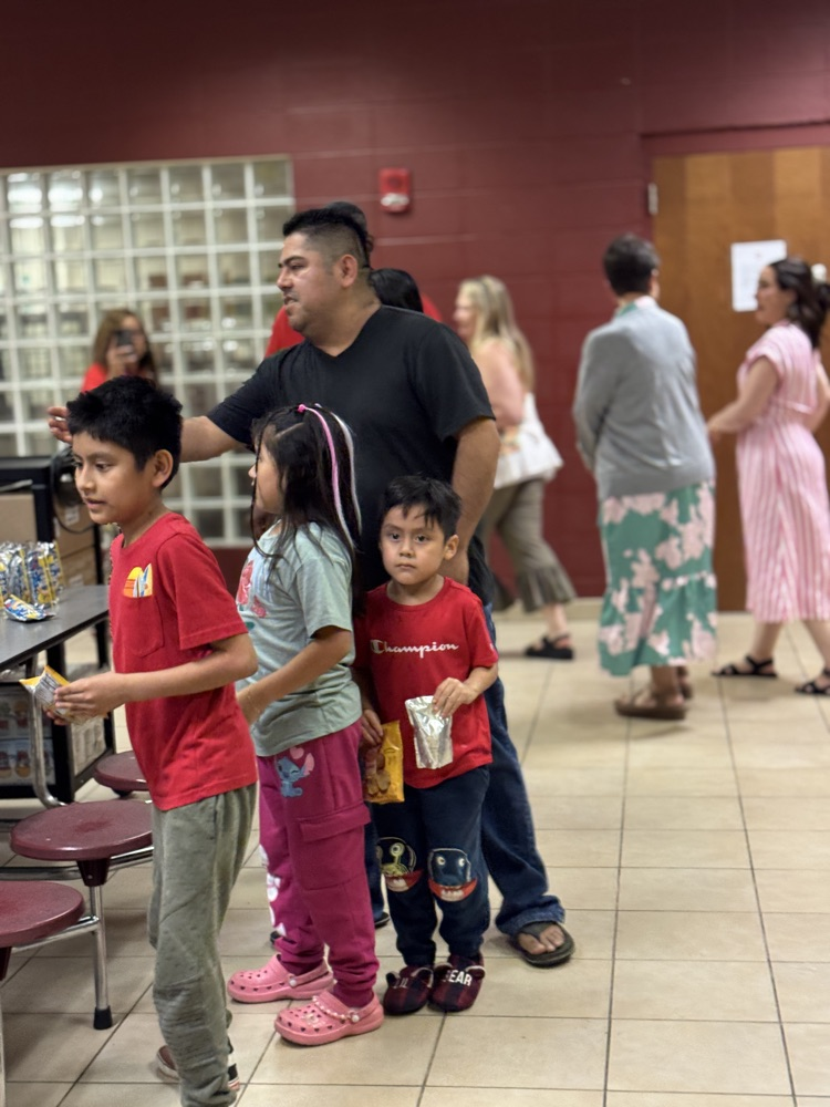 parents and children in the lunchroom of a school