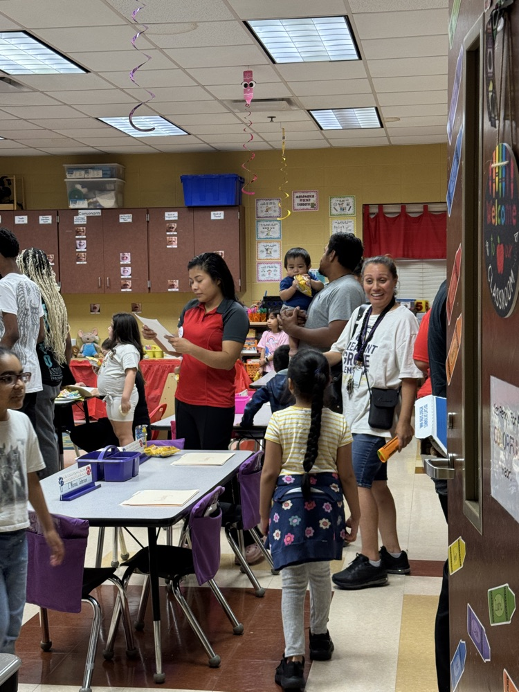 parents and students visiting a classroom