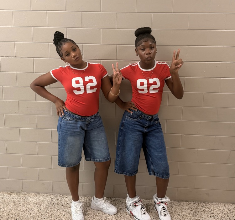 Two HMS students pose in matching red number 92 shirts and denim shorts for Two to Tango Day.