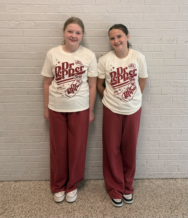Two HMS students pose in matching Dr Pepper shirts and maroon pants for Two to Tango Day.