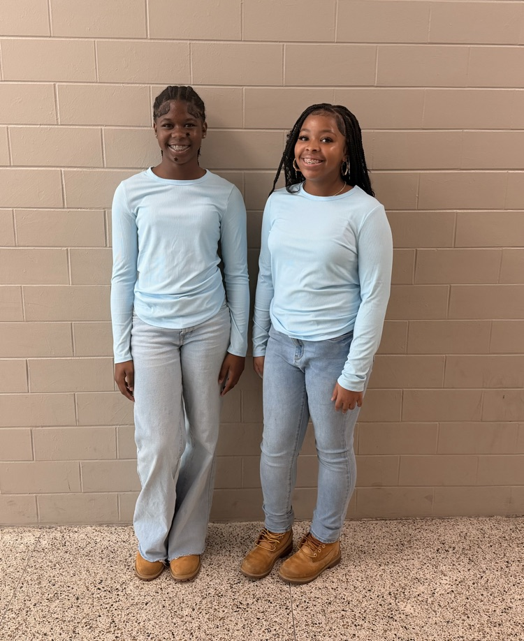 Two HMS students pose in matching light blue shirts and jeans for Two to Tango Day.