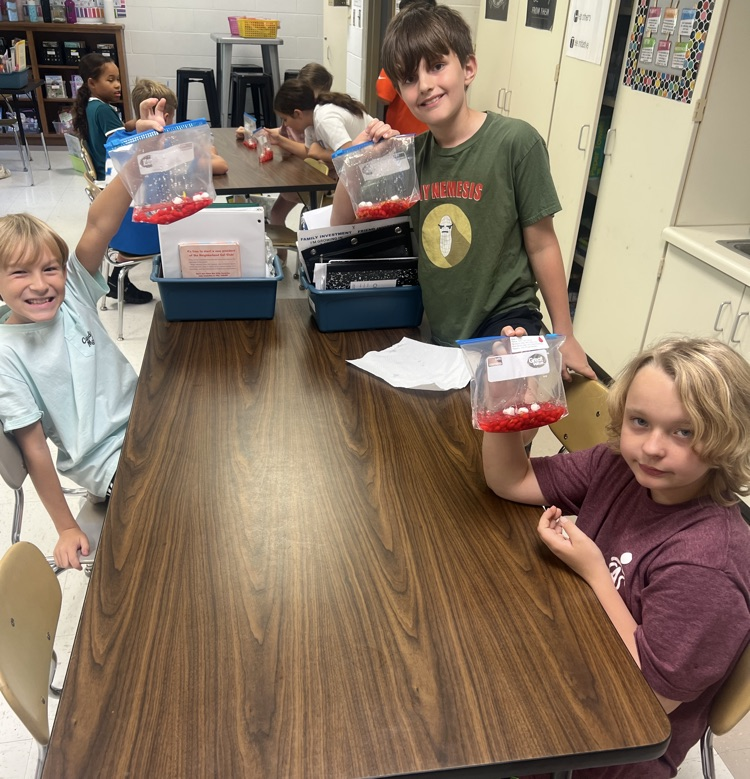 4th grade boys at their table posing with blood bags