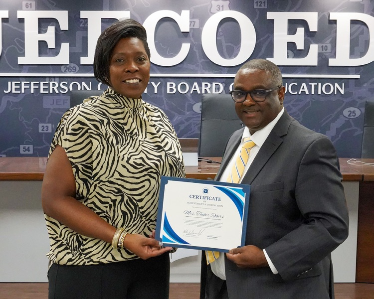 Tinker Rogers and JEFCOED Superintendent Dr. Gonsoulin pose for a photo inside the JEFCOED board room  